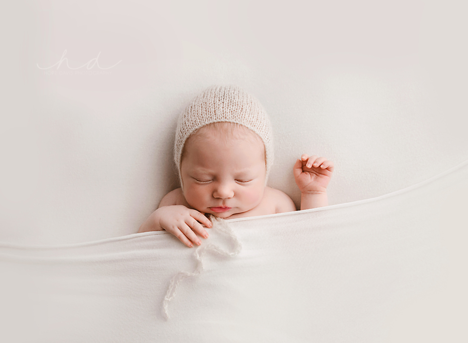 baby in bonnet white simple newborn photography hope davis photographer