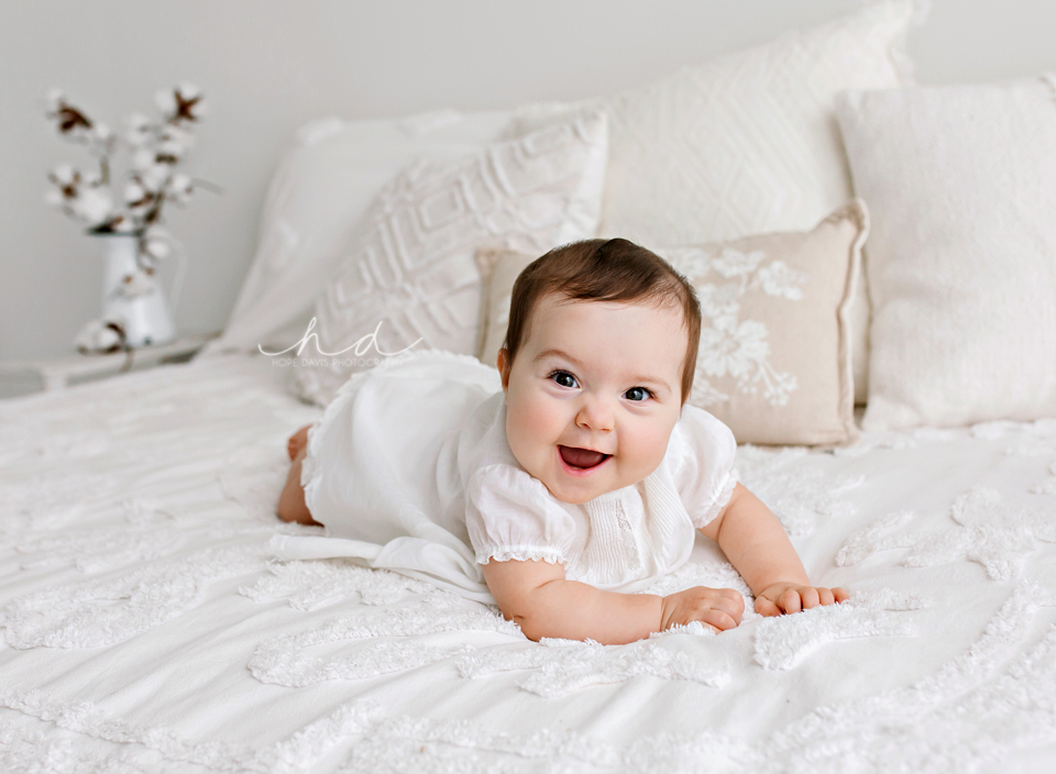 baby girl on bed in heirloom dress