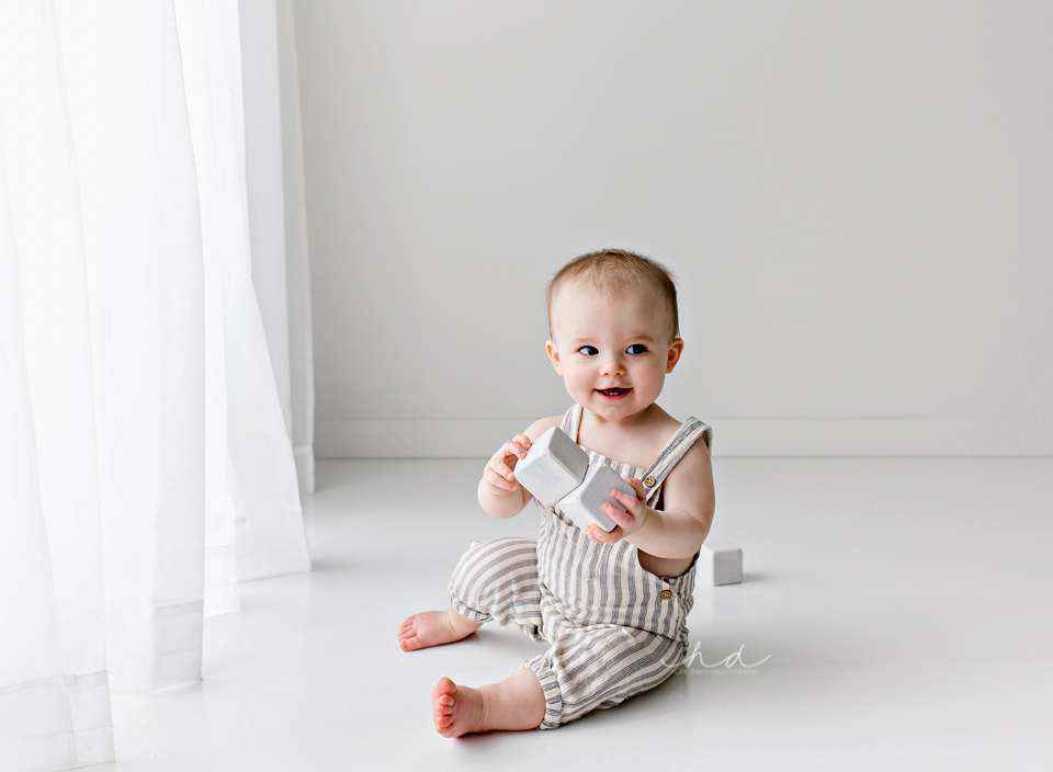 one year old boy playing with blocks photo shoot