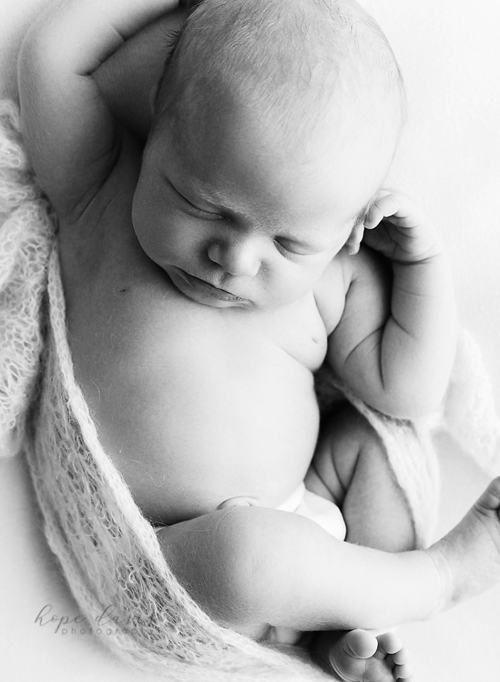 brandon mississippi newborn photographer baby curled up on blanket