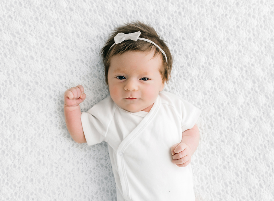 Baby on a white knit blanket professional photography studio in Meridian Mississippi