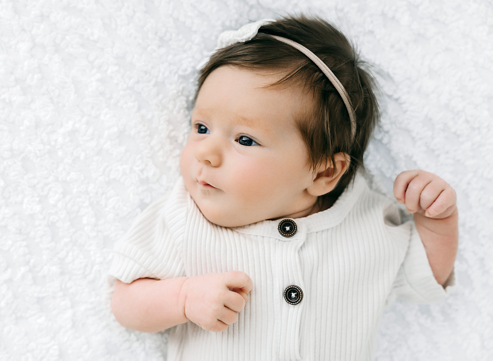 baby on white knit blanket