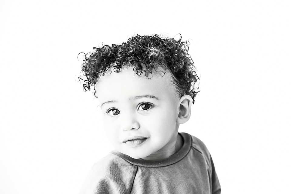 Expressive baby photo of Cruz with wide eyes and a slight grin, photographed in Decatur, Mississippi