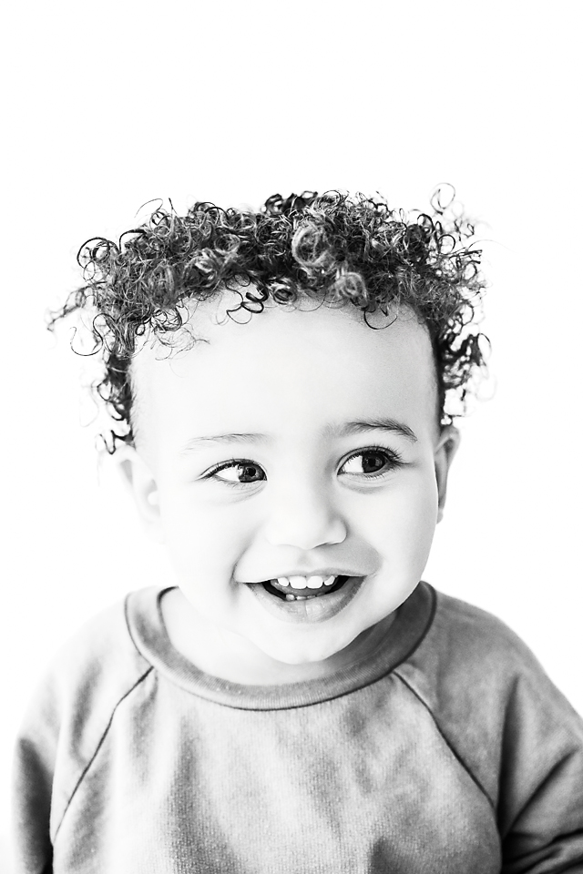 Expressive baby photo of Cruz with wide eyes and a slight grin, photographed in Decatur, Mississippi