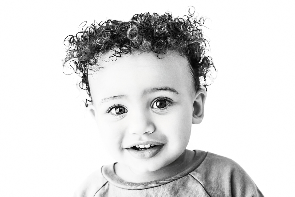 black and white portrait of one year old with curly hair