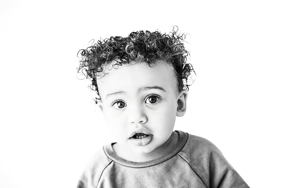 Classic black and white toddler portrait with neutral background and natural lighting