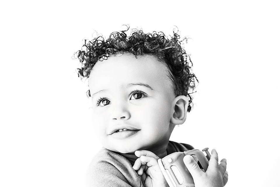 Timeless black and white image of toddler boy during monthly Little Faces kids session